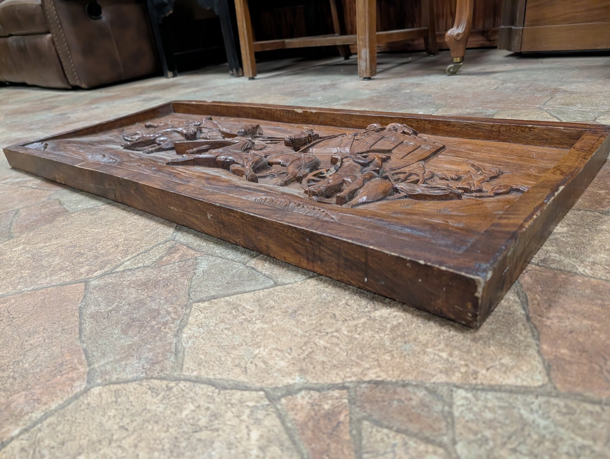 Side angle showing the carved stagecoach scene with pursuing horsemen