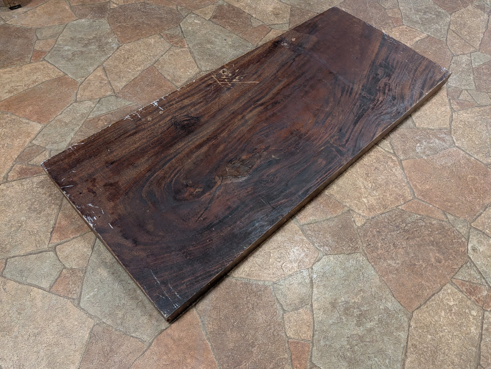 Overhead view of the back showing the full wood slab and hanging hardware evidence