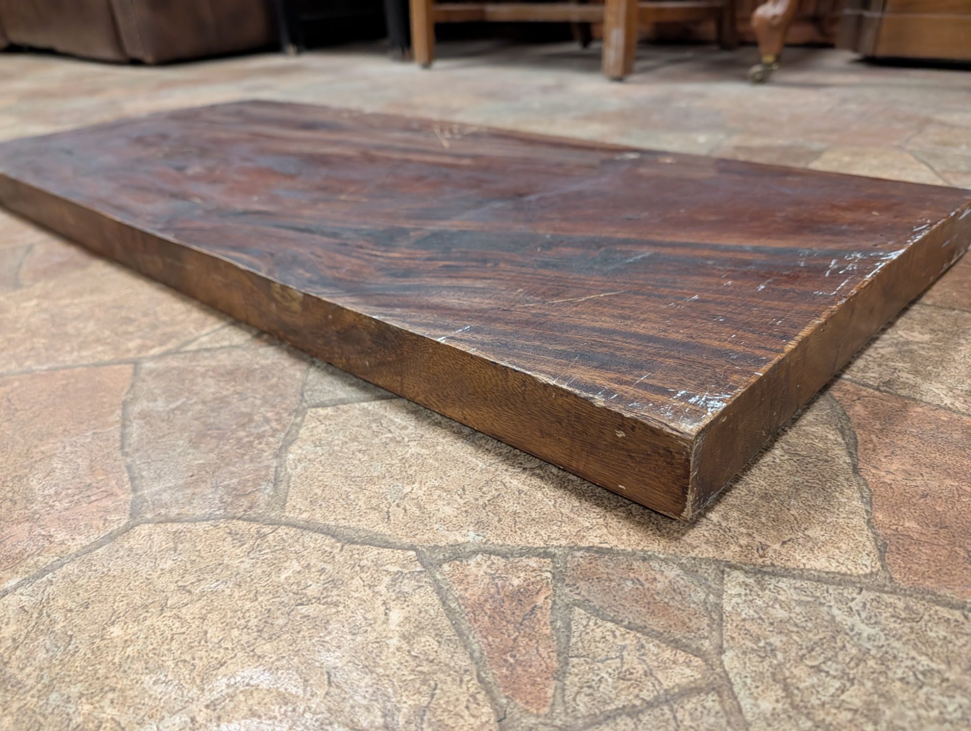 Side view showing the substantial thickness of the single piece of carved wood