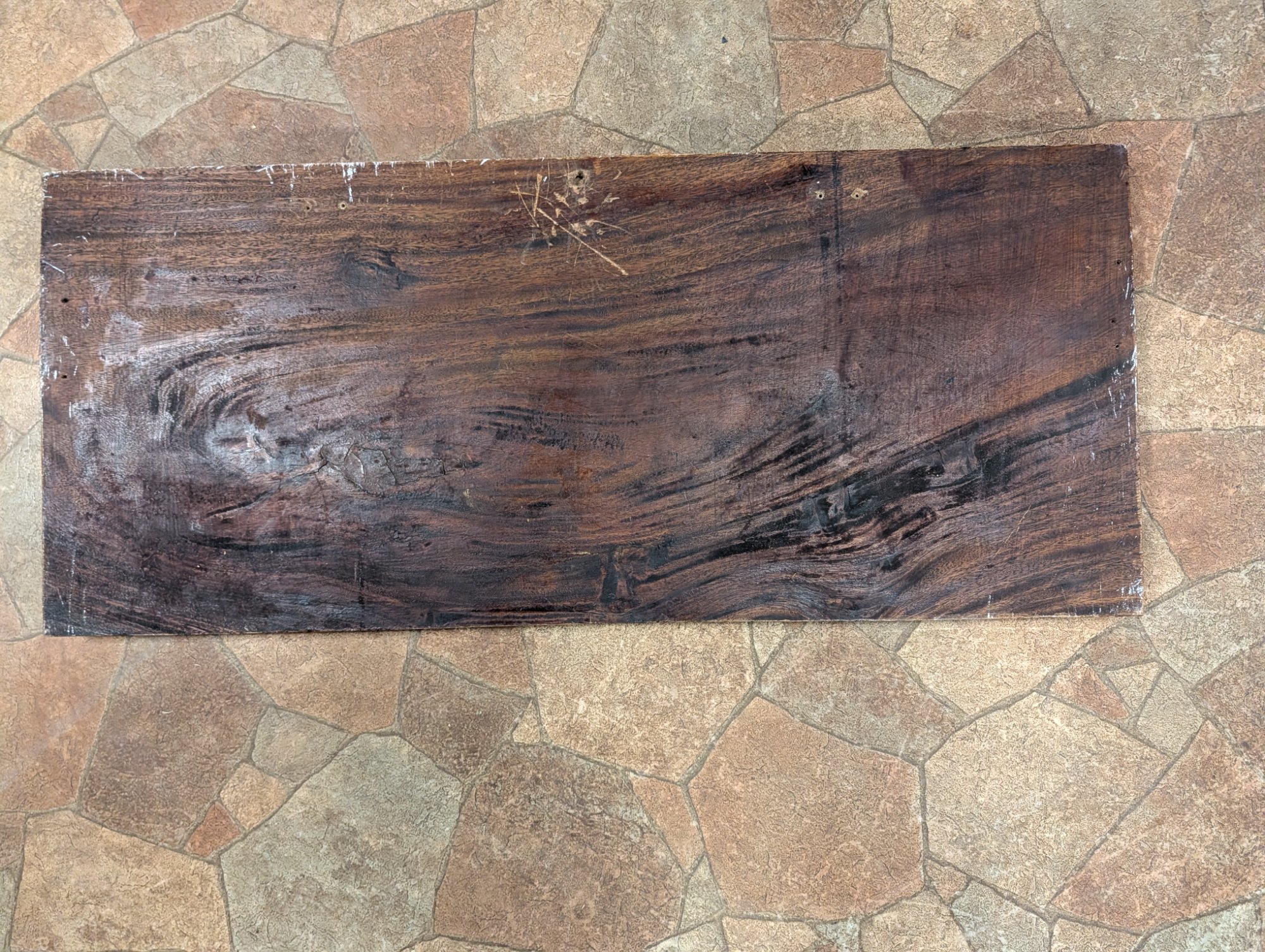 Full back view showing the single-piece wood construction, nail holes, and chisel marks